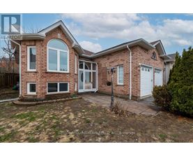 A brick house with a white door and windows is for sale.