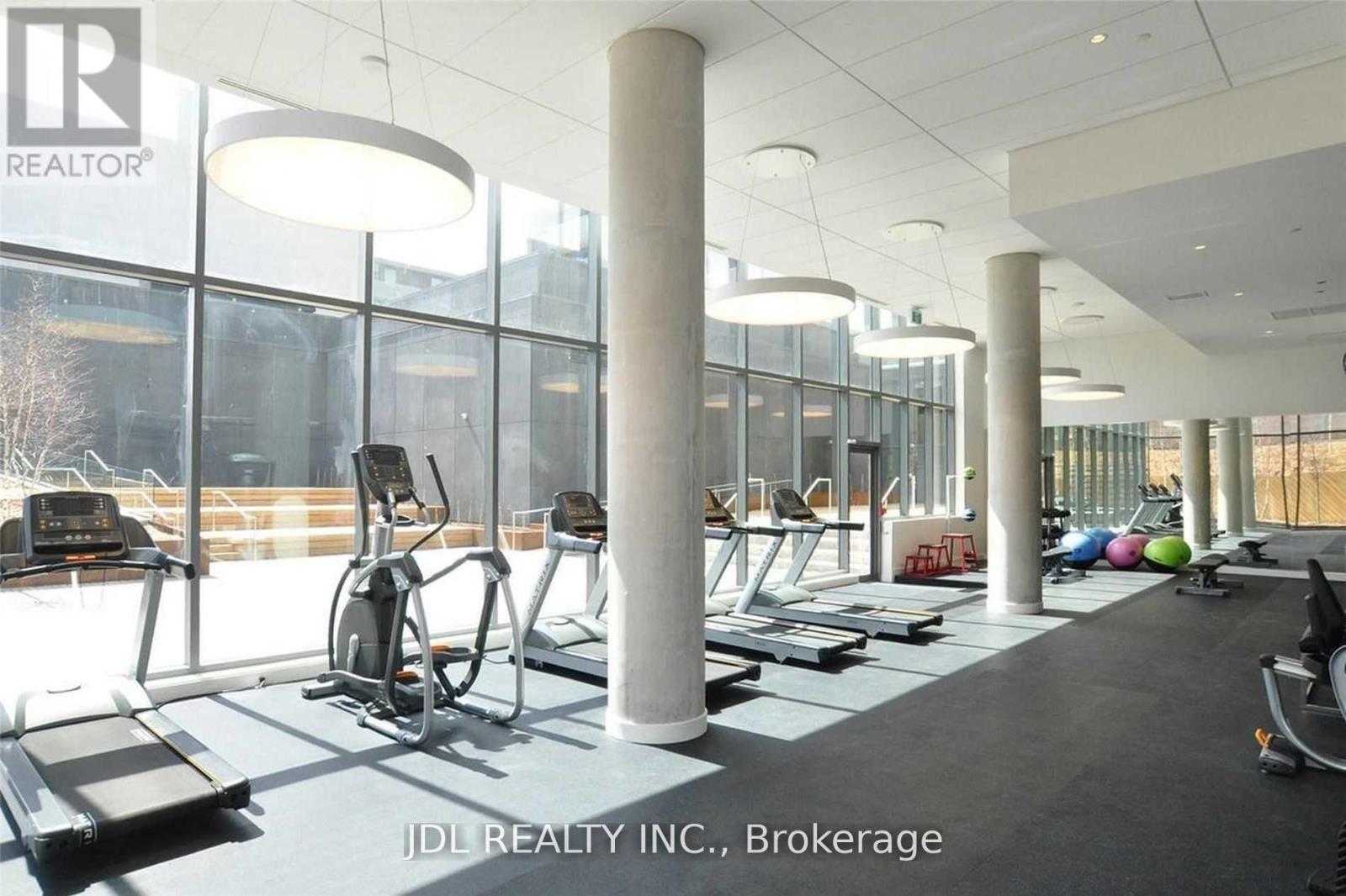 A gym with treadmills, elliptical machines and other equipment.