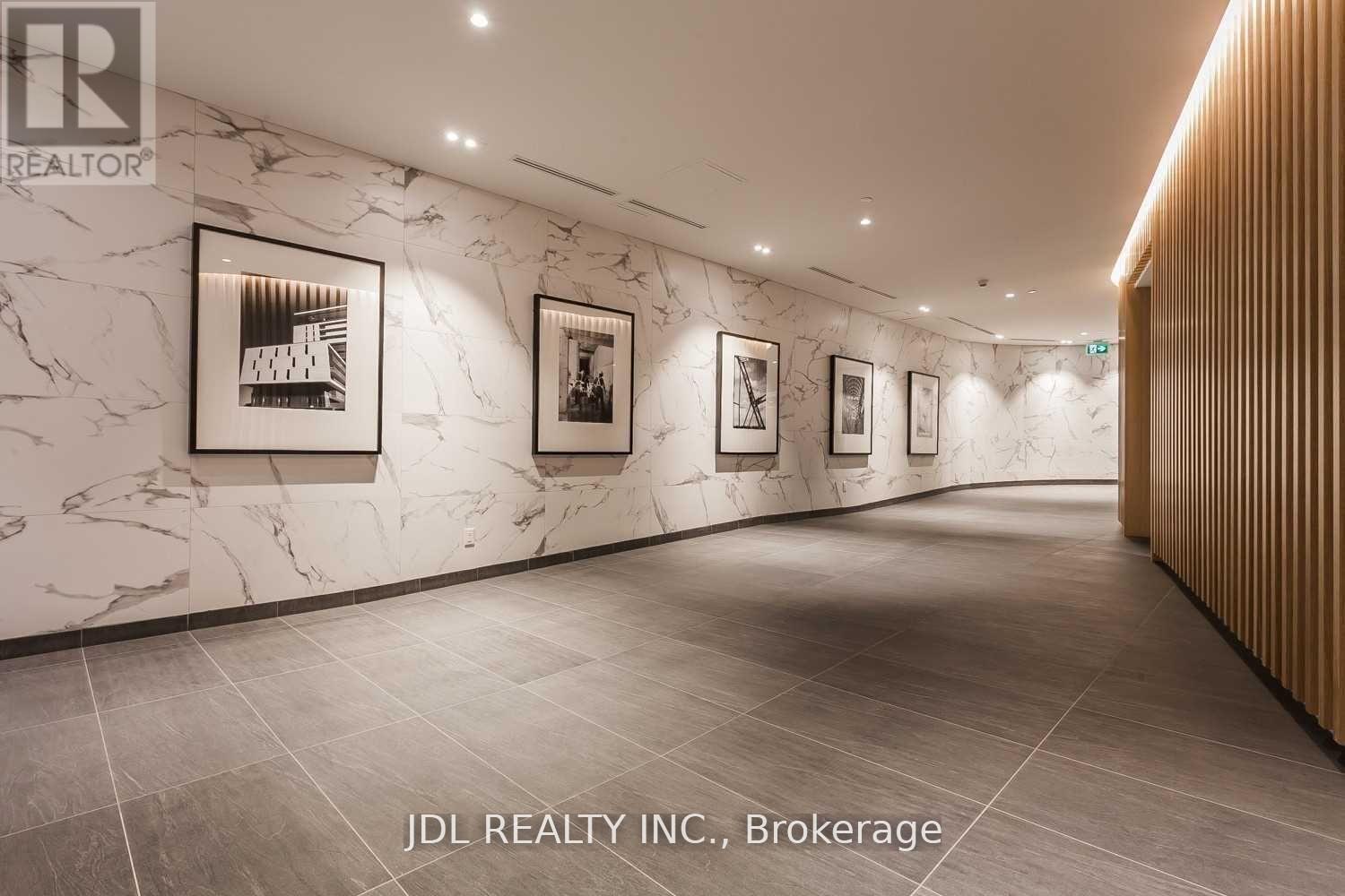 A hallway with marble walls and wooden paneling on the side.