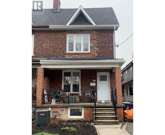 A brick house with a white door and windows.