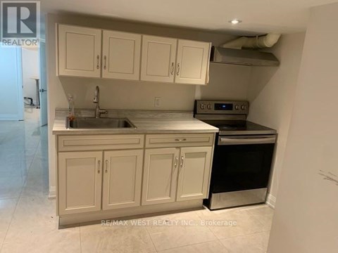 A kitchen with white cabinets and a stainless steel dishwasher.