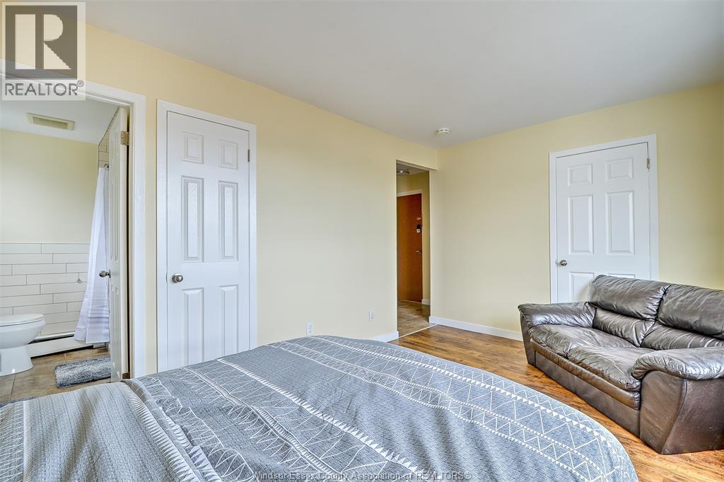 A bedroom with a bed and a couch.