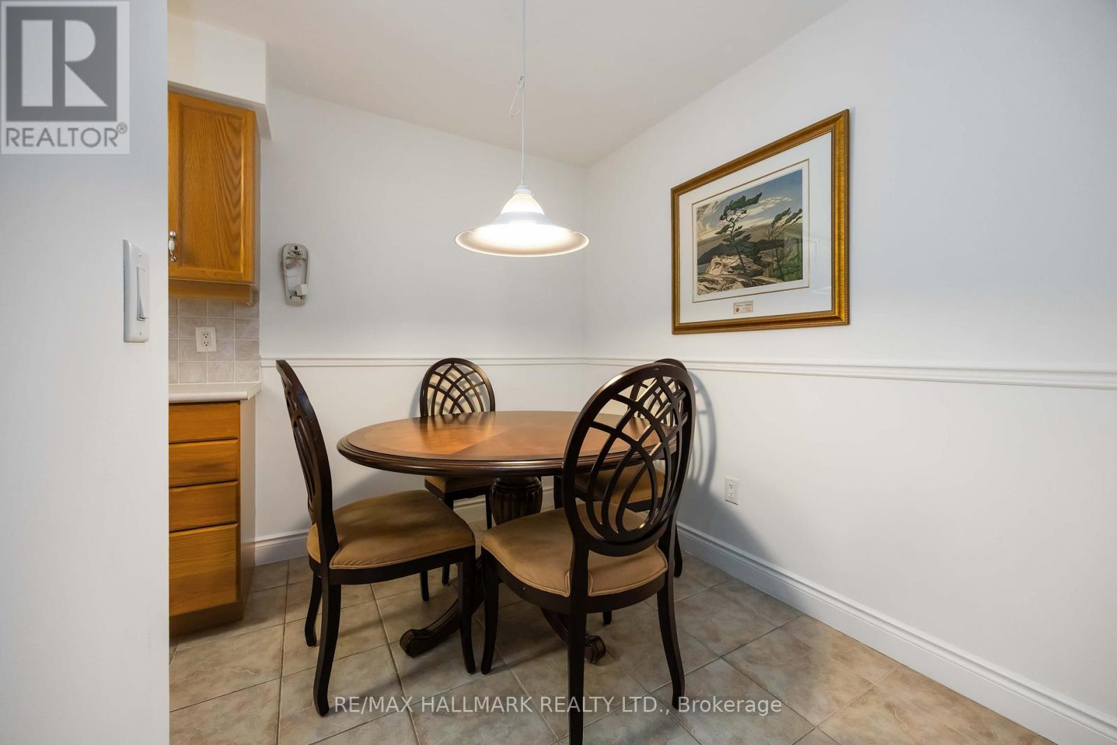 A dining room with a table and chairs.