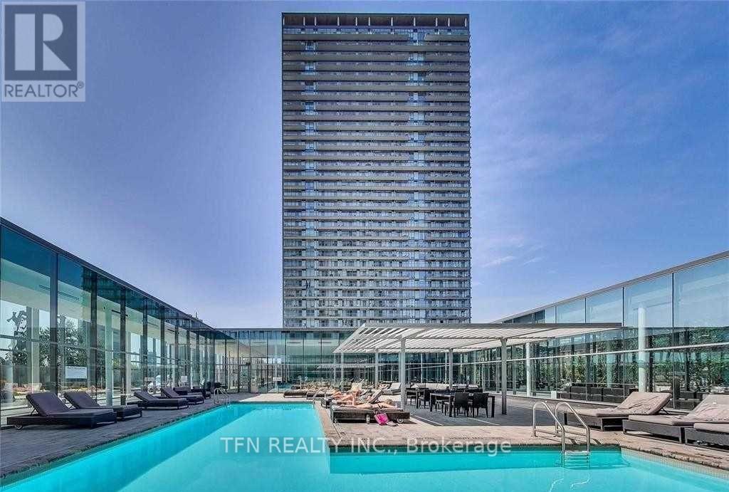A modern building with a pool in front of it.