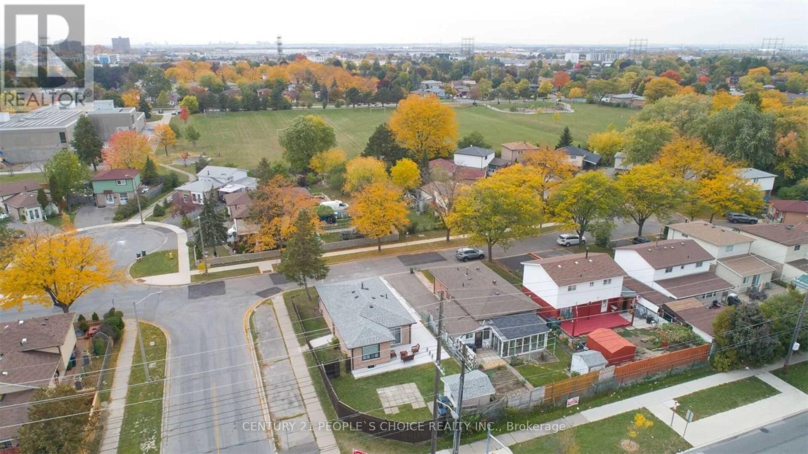 A suburban neighborhood with houses and trees in autumn colors.