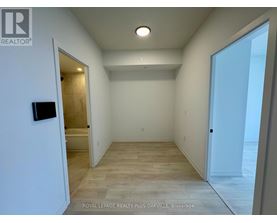 A spacious room with a doorway leading to another room.