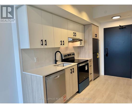 A kitchen with white cabinets and black appliances.