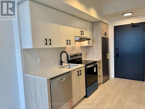 A kitchen with white cabinets and black appliances.