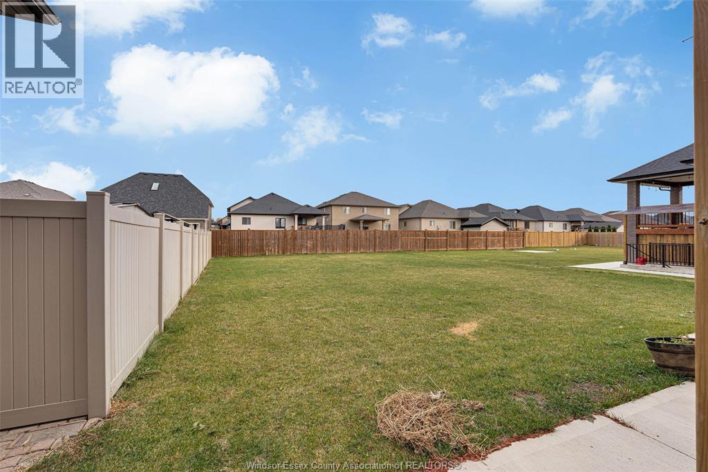 A row of houses with a grassy yard in front.
