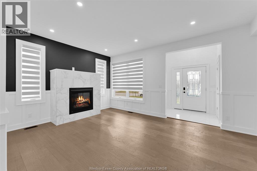 A modern living room with a fireplace and a large window.