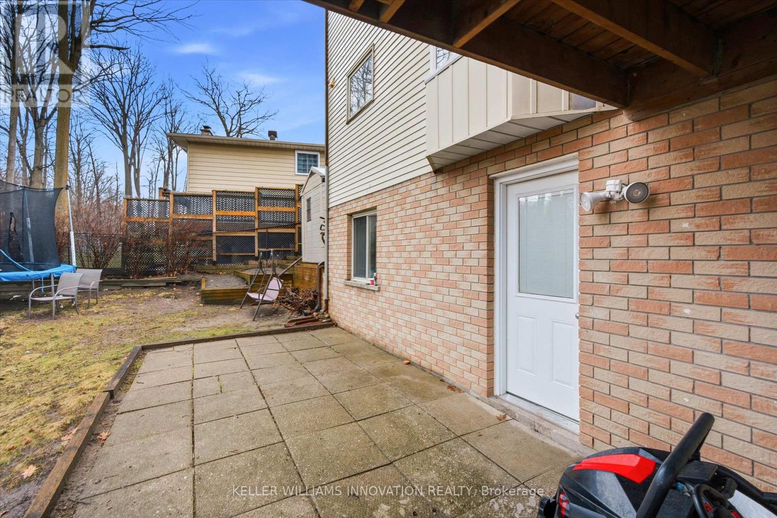 A backyard with a patio and a brick wall.