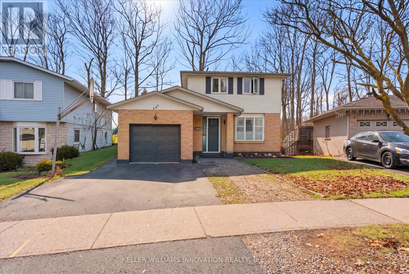 A house with a driveway and a car parked in front.