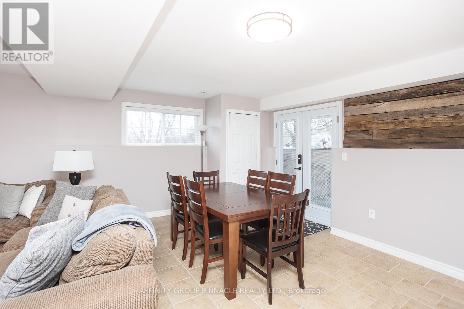 A dining room with a wooden table and chairs.