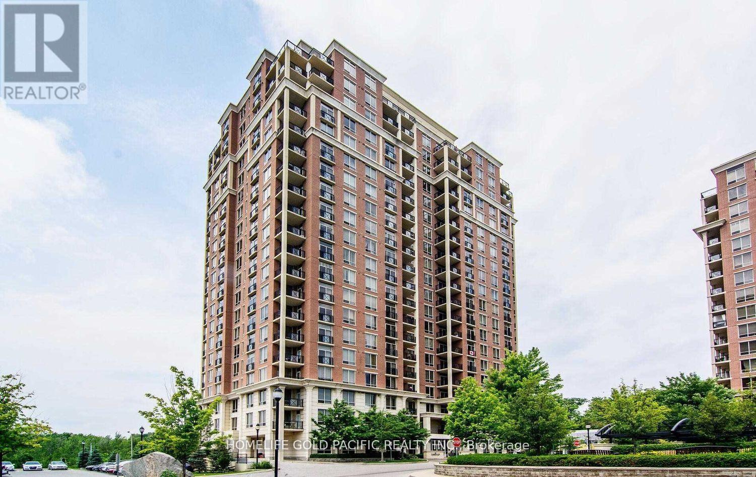 A tall residential building with a sign that reads "Cold Pacific Realty" in front of it.