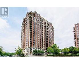 A tall residential building with a sign that reads "Cold Pacific Realty" in front of it.