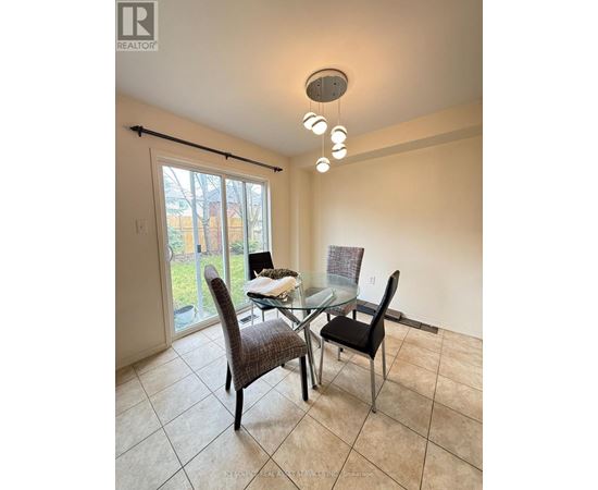 A dining room with a glass table and chairs.