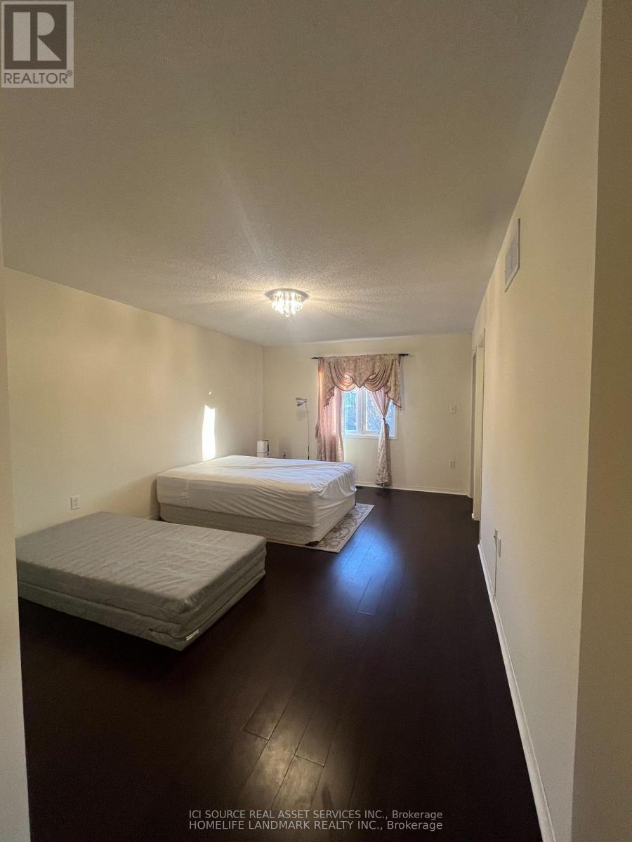 A bedroom with two beds and a window with curtains.