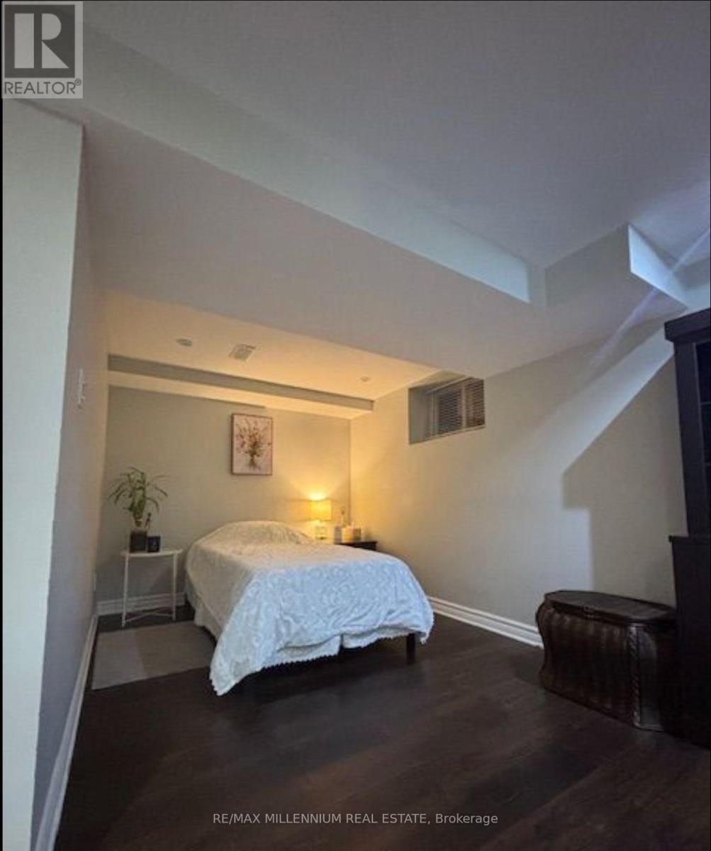 A bedroom with a bed, nightstand, and chair.