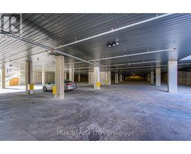 A spacious, empty parking garage with a car parked in the middle.
