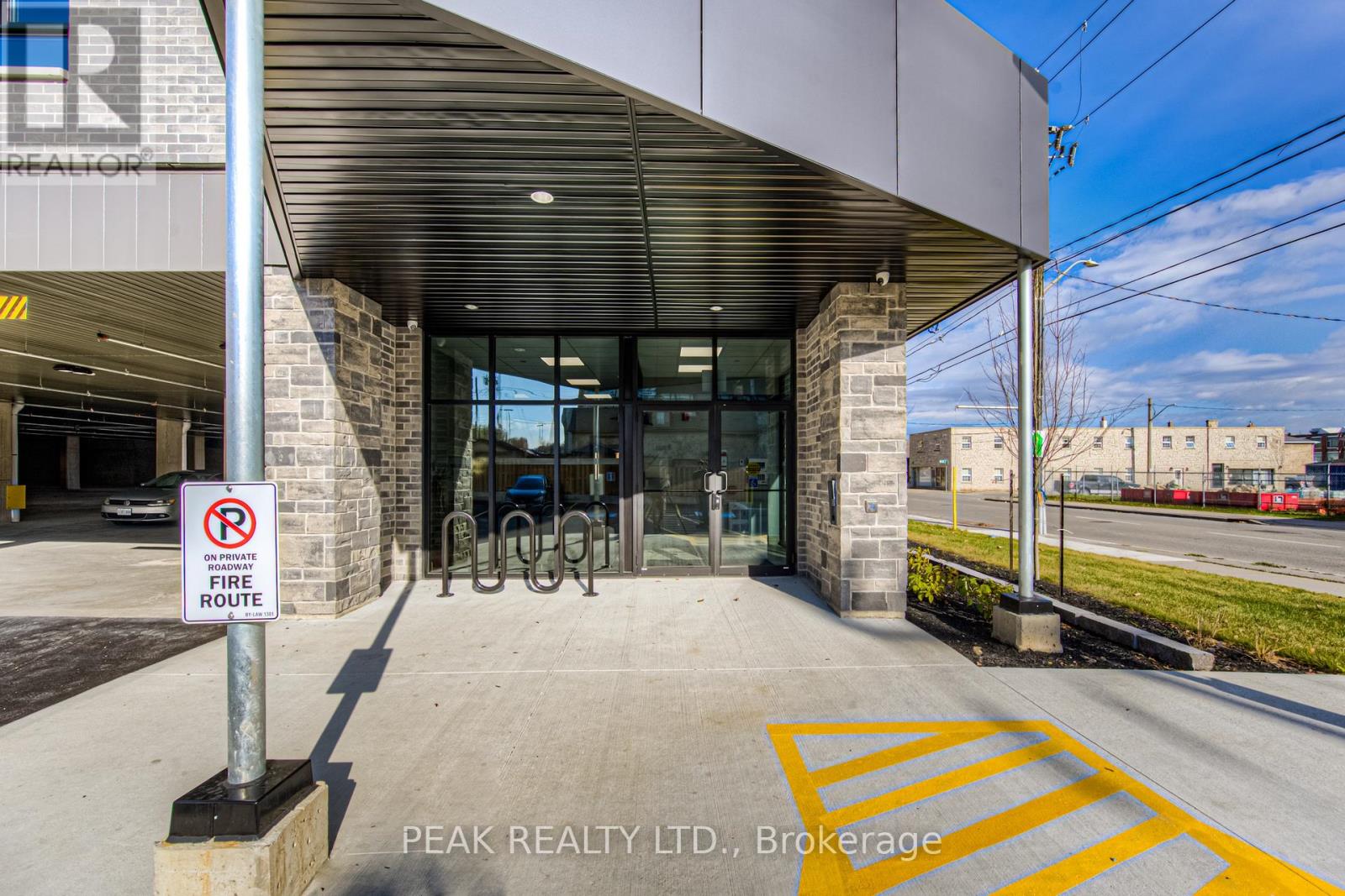 The entrance to Peak Realty LTD. in Brokerage is shown with a no parking sign.
