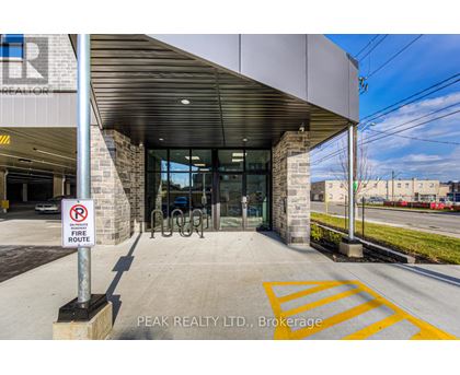 The entrance to Peak Realty LTD. in Brokerage is shown with a no parking sign.