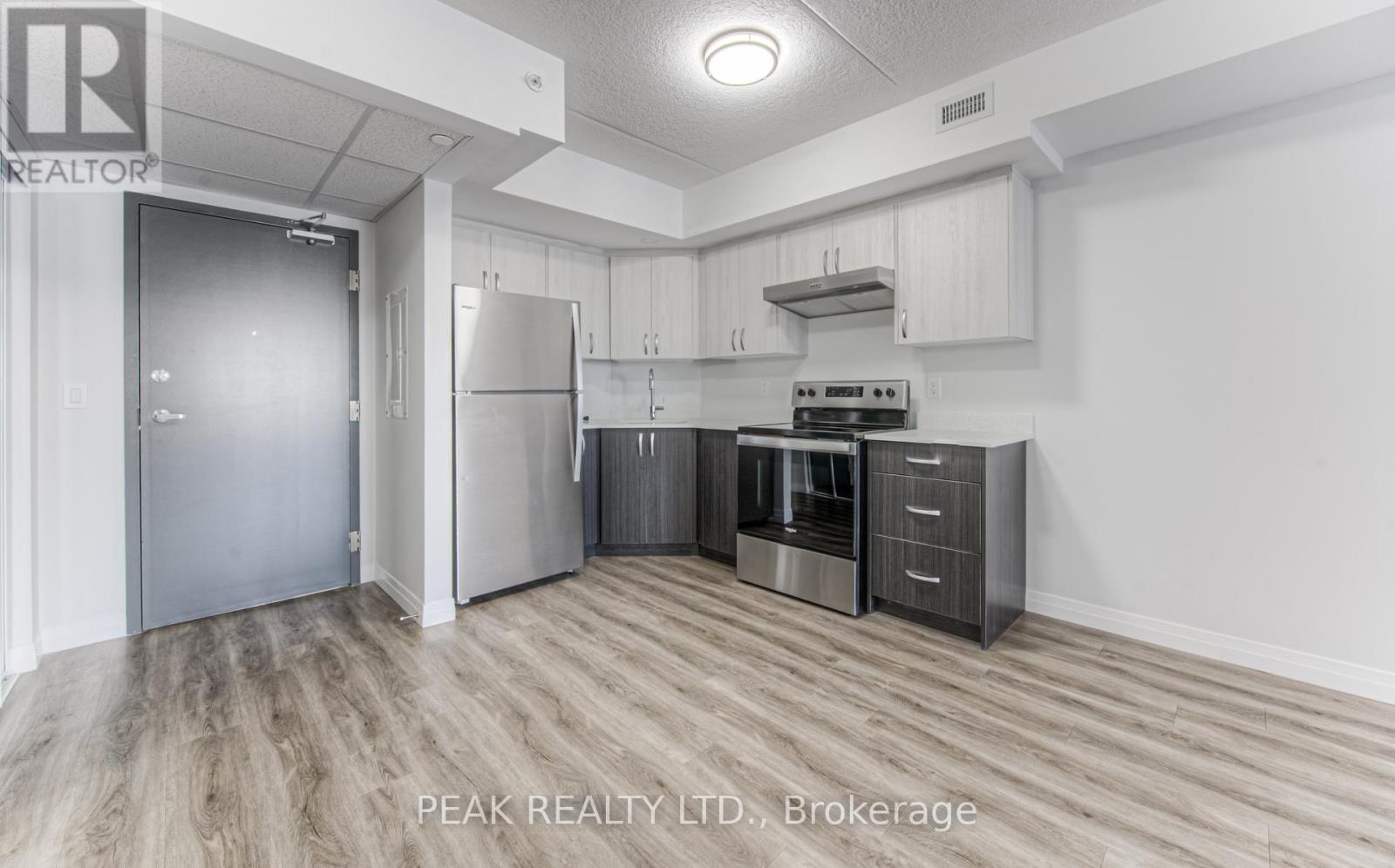 A kitchen with a refrigerator, stove, and oven.