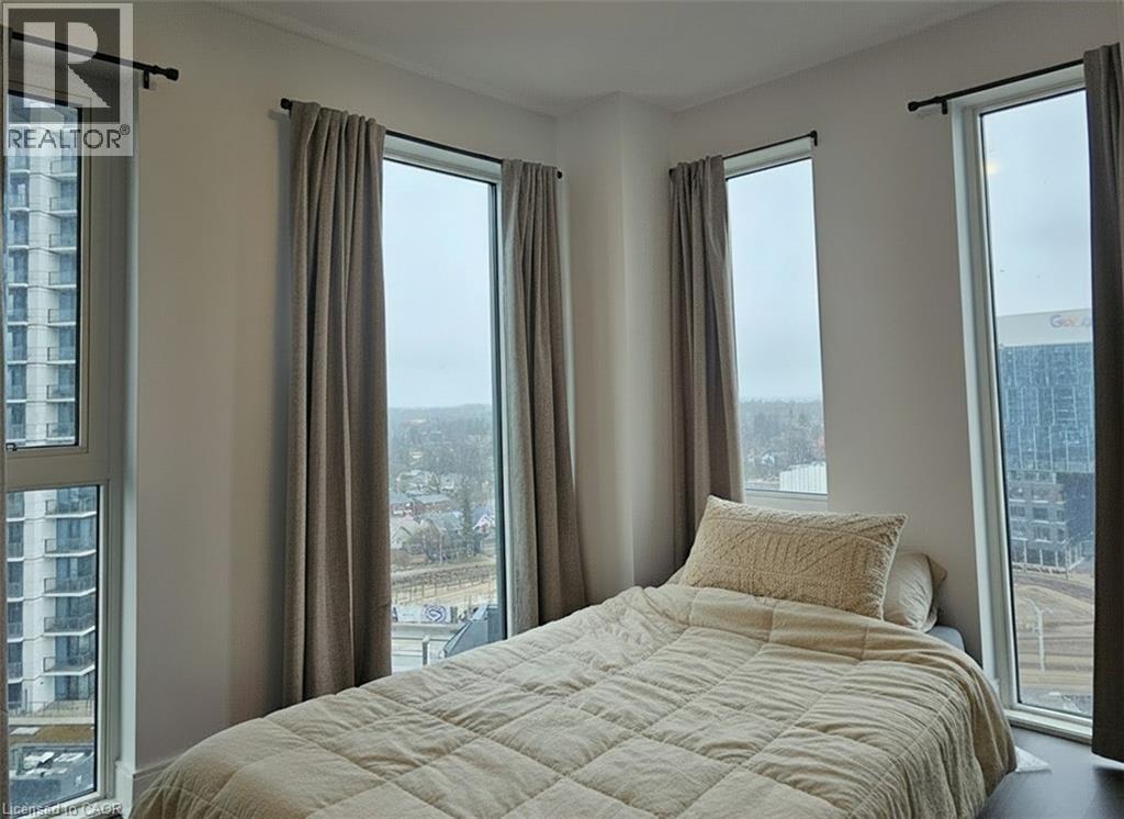 A bedroom with a large bed and a view of the city.