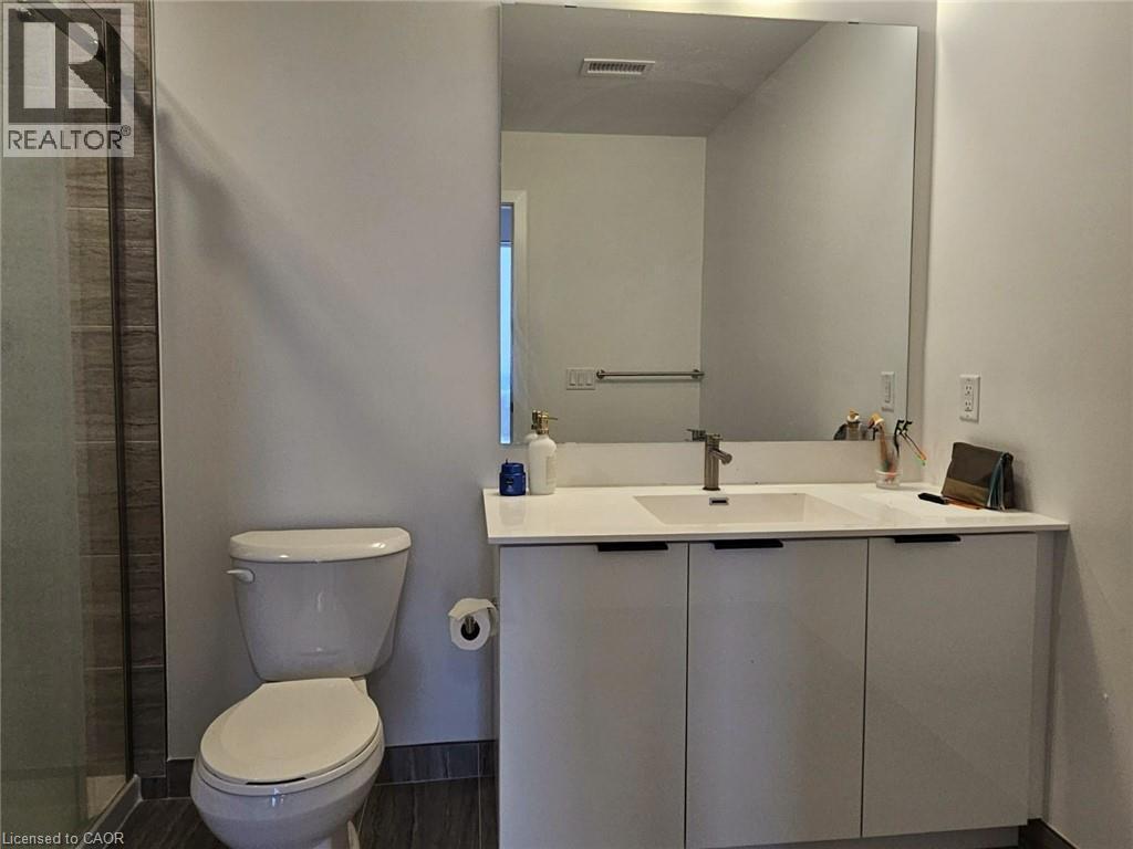 A white toilet sits next to a sink in a bathroom.