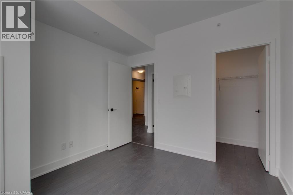 A spacious room with a door at the end of the hallway.