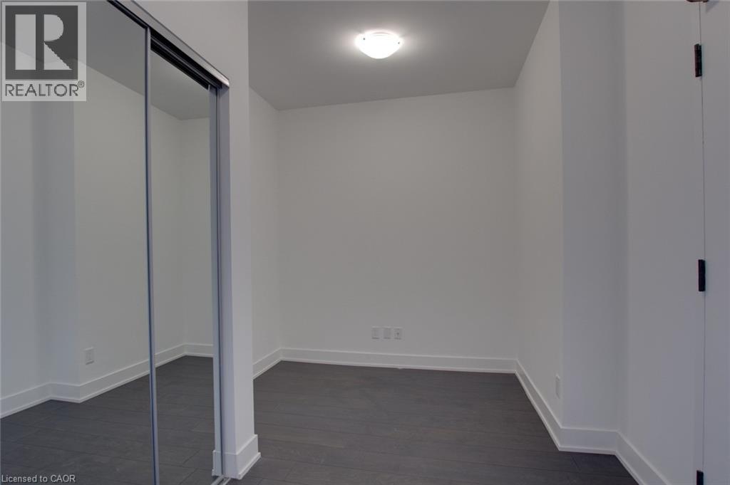 A room with a sliding glass door and a white wall.