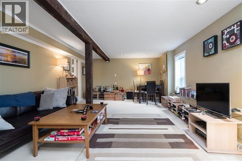 A living room with a blue couch and a wooden coffee table.