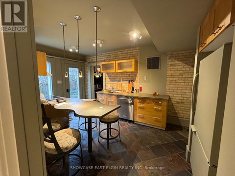 A kitchen with a table and chairs in the middle of the room.