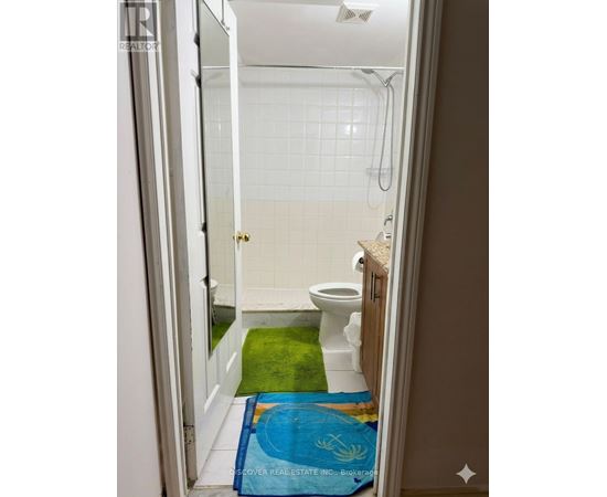 A bathroom with a toilet, sink and shower.