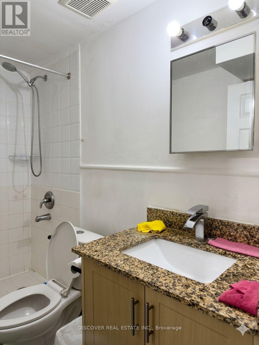 A bathroom with a sink, toilet and shower.