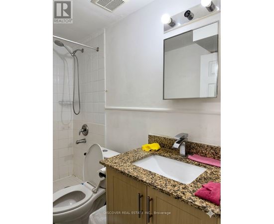 A bathroom with a sink, toilet and shower.