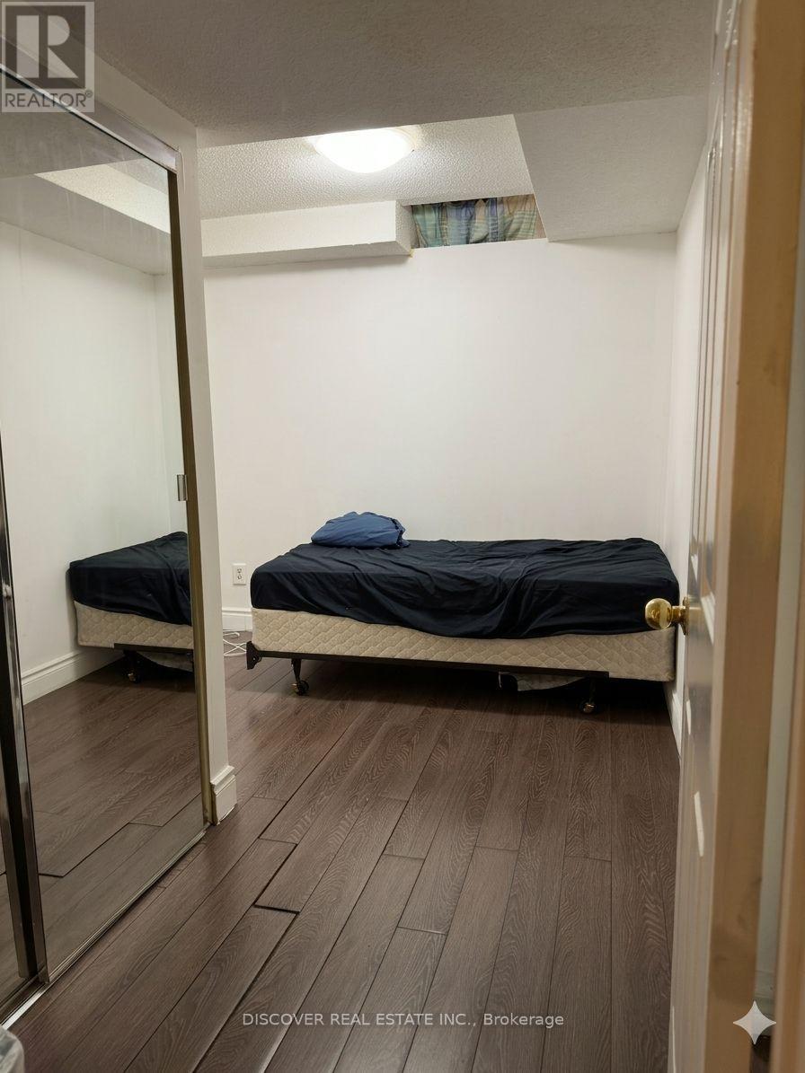 A bedroom with a bed and a mirror on the wall.