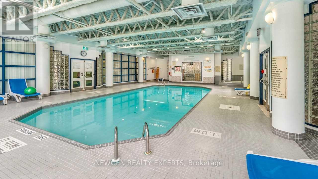 A large indoor swimming pool with a blue lane divider.