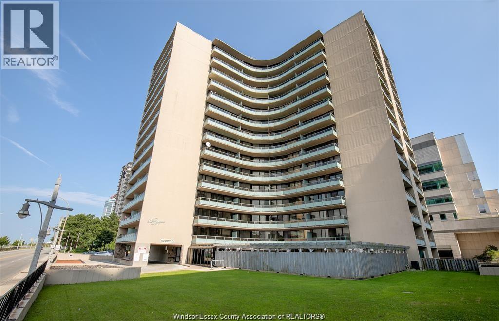 A tall building with a curved facade and balconies on each floor.