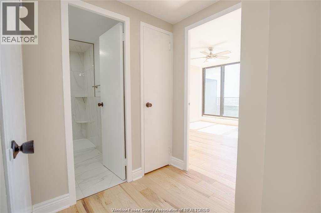 A bedroom with a sliding door leading to a balcony.