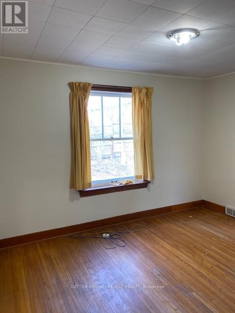 A room with a window and curtains.