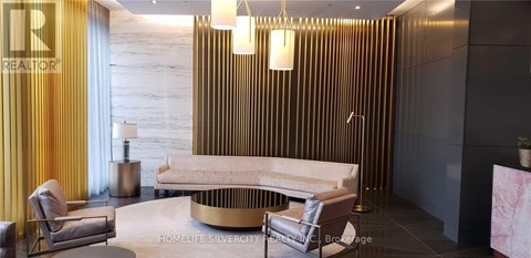 A modern living room with a white sofa and a gold coffee table.