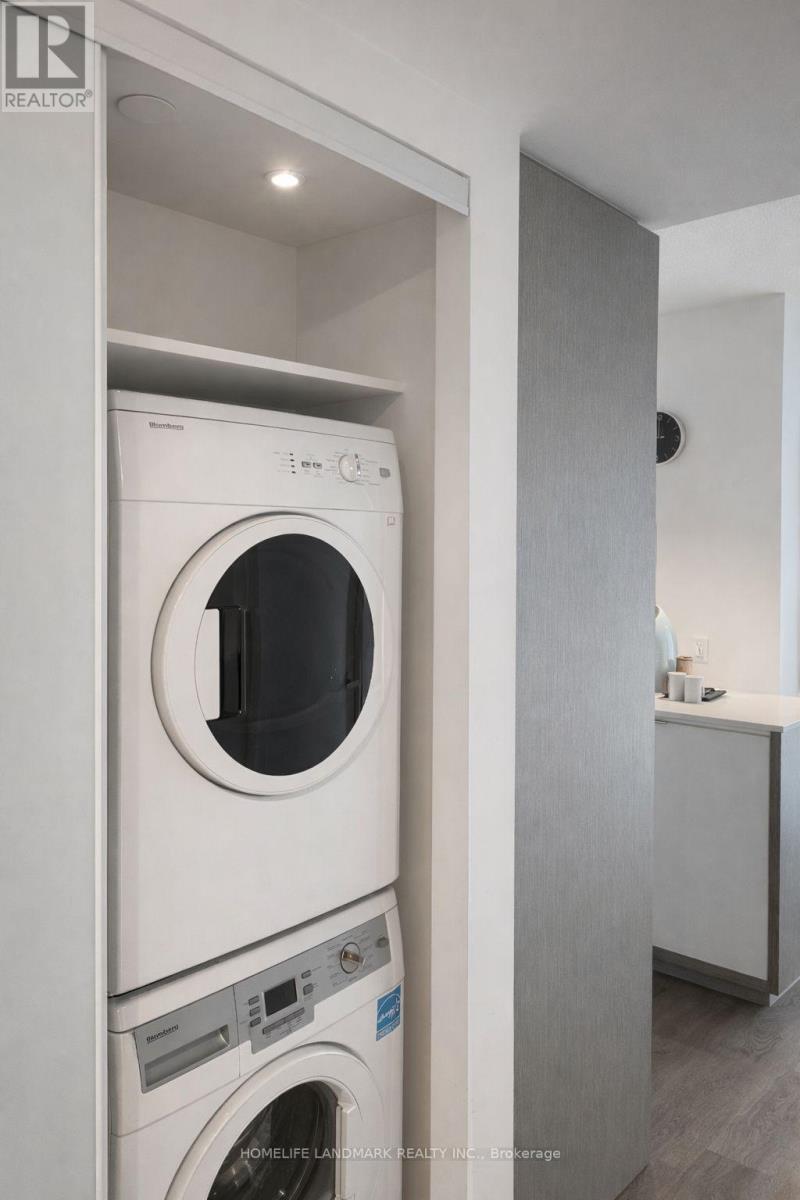 A white washing machine is in a small laundry room.