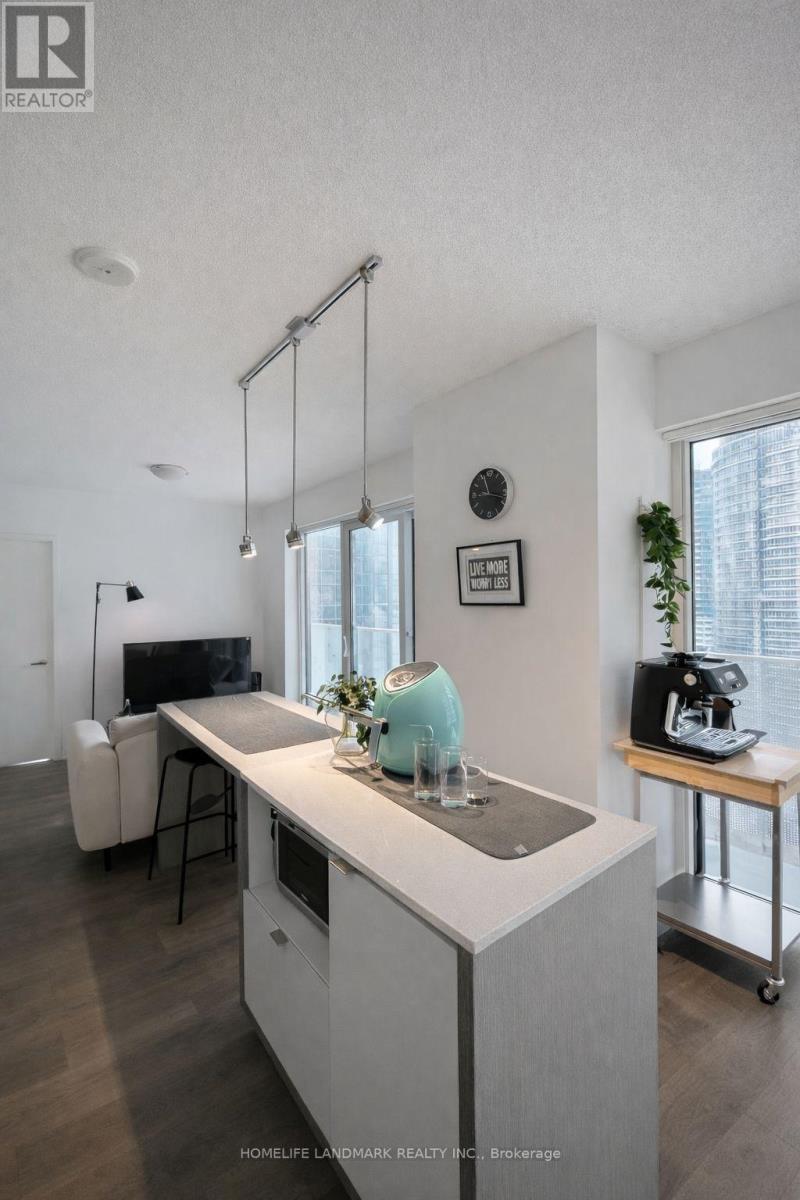 A modern kitchen with a white countertop and a sink.