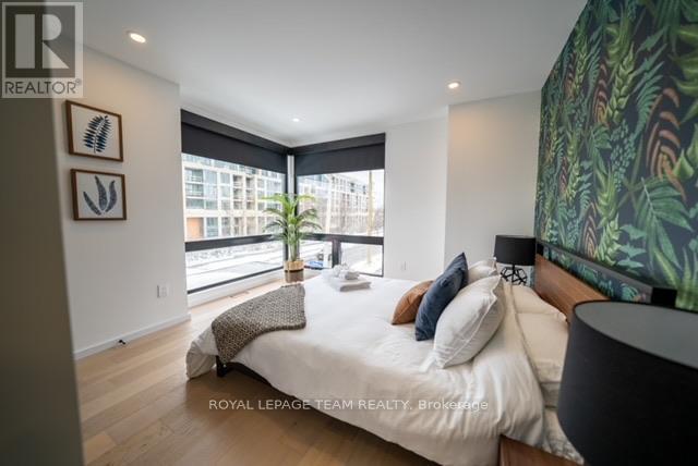 A bedroom with a large bed and a large window.