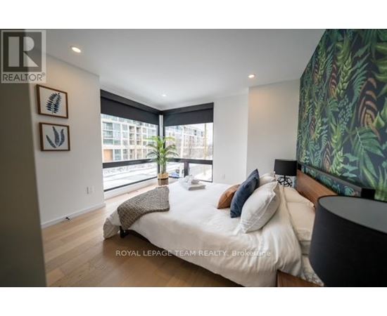 A bedroom with a large bed and a large window.