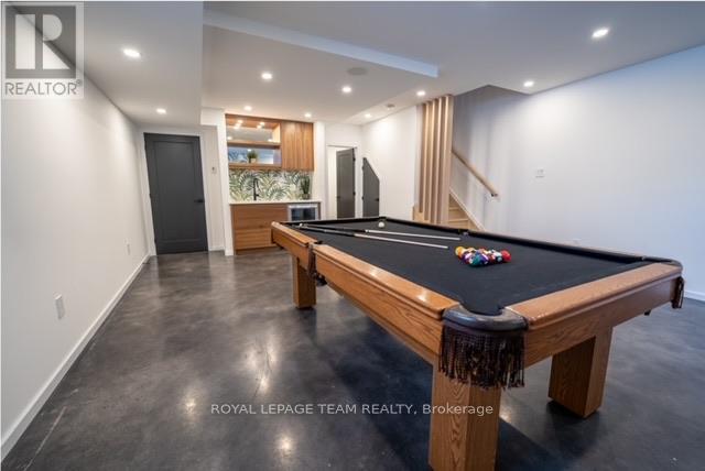 A pool table in a room with a leopard print skirt on it.