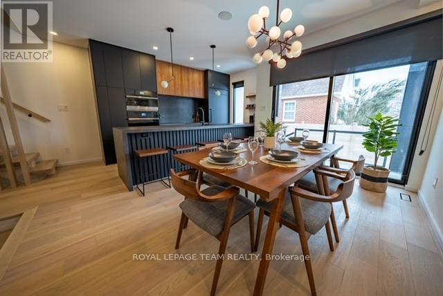 A dining room with a wooden table and chairs.
