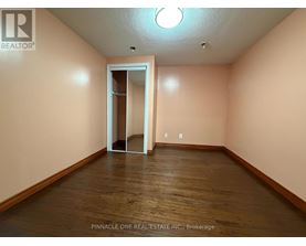 A room with a wooden floor and a white door.
