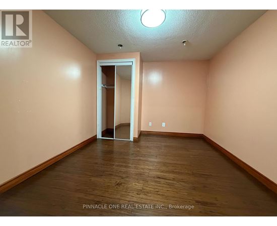 A room with a wooden floor and a white door.