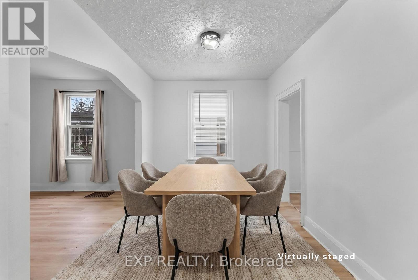 A dining room with a table set for six.